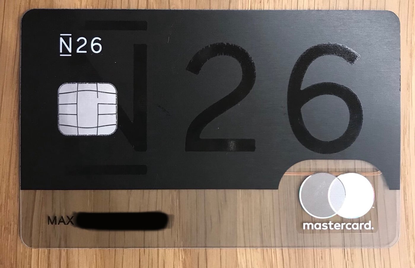 An N26 Black Mastercard resting on a wooden surface