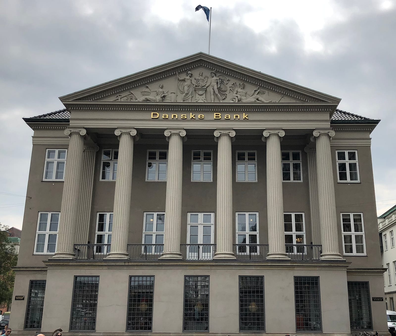 The neoclassical Danske Bank headquarters building in Copenhagen, with columns and the bank's name in gold lettering