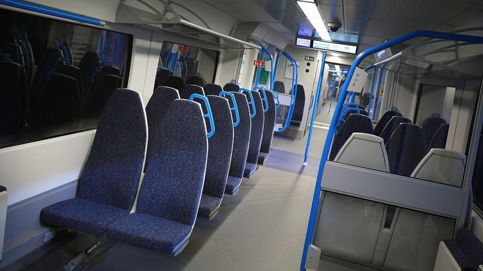 Interior of a Thameslink train showing thin commuter seating