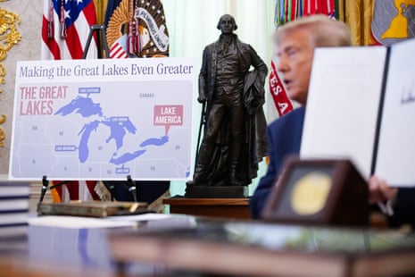 Donald Trump signing an executive order at a desk in the Oval Office