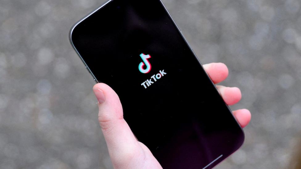 The TikTok logo on a phone screen